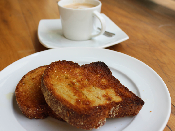 Da nova Grão Fino, padaria com receitas sem glúten ou lacotese: pão na chapa (de painço) com ghee e café com leite de castanha de caju 