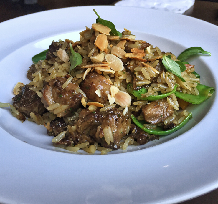 Arroz de cordeiro com carne extremamente macia, pedaços de ervilha torta, amêndoas tostadinhas e poejo (R$ 42)