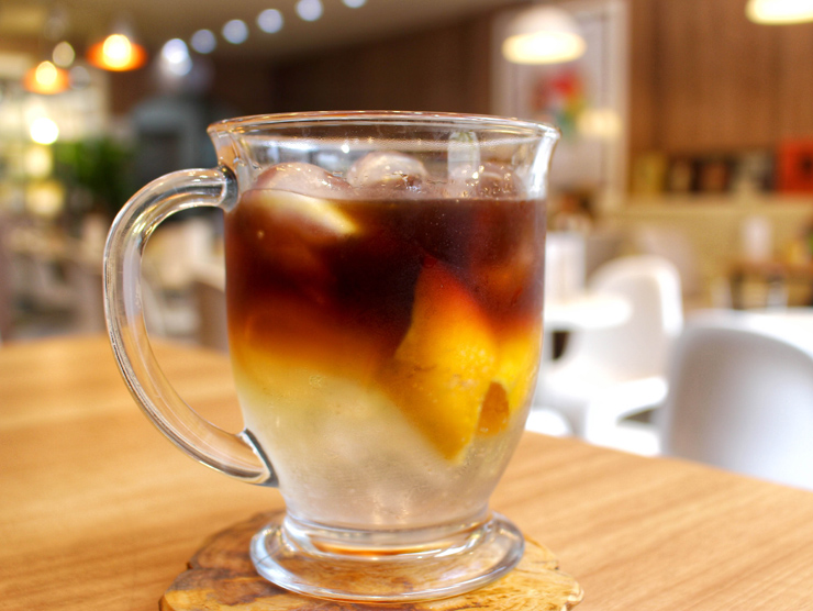 Café extraído a frio (cold brew), tônica, casca de laranja e gelo